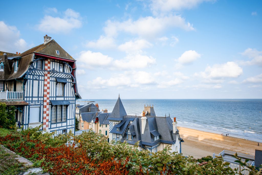 view of the town of Trouville with the beach in the background - hotel near deauville