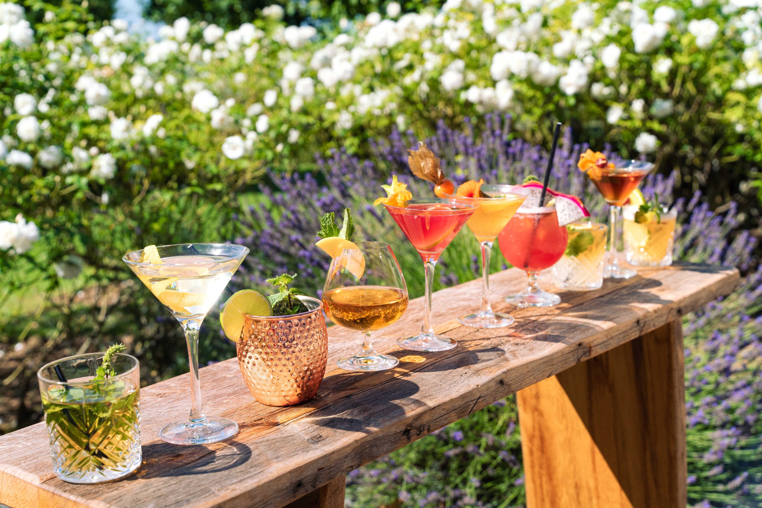 A table in the gardens of the Saint Siméon Farm, with various cocktails made by our barman